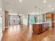 Expansive open floorplan showcases a kitchen with island, adjacent to a comfortable living area and fireplace at 4197 Canopy Creek Dr, Denver, NC 28037