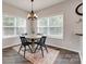 Bright dining area with hardwood floors, a chandelier, and a view of the outside at 424 Castlebury Ct, Clover, SC 29710