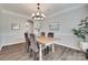 Dining area features chair rail, wood flooring, modern lighting and neutral paint at 424 Castlebury Ct, Clover, SC 29710