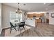 Inviting dining area near the kitchen, featuring hardwood floors and a modern chandelier at 424 Castlebury Ct, Clover, SC 29710