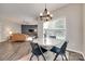 Bright dining space with hardwood floors, modern lighting, and open access to the living room at 424 Castlebury Ct, Clover, SC 29710