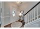 Bright foyer featuring hardwood floors, a staircase with white railings, and a decorative mirror at 424 Castlebury Ct, Clover, SC 29710