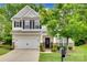 Charming two-story home features a two-car garage, stone accents, and a welcoming front porch at 424 Castlebury Ct, Clover, SC 29710