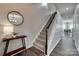 Hallway with wood flooring, carpeted stairs, and view into a dining area at 424 Castlebury Ct, Clover, SC 29710