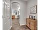 Hallway leading to a kitchen, with wood flooring and a decorative cabinet at 424 Castlebury Ct, Clover, SC 29710