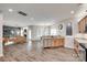 Open-concept living space featuring a modern kitchen, cozy seating area, and hardwood flooring throughout at 424 Castlebury Ct, Clover, SC 29710