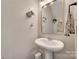 Neat powder room featuring pedestal sink, framed mirror and neutral paint at 424 Castlebury Ct, Clover, SC 29710