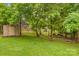 The property features a fenced yard with outbuilding, storage shed and mature trees for a private and secure outdoor space at 44092 Woodhurst Rd, New London, NC 28127