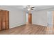 Bedroom featuring wood floors, a ceiling fan, closet, and an ensuite bathroom at 44092 Woodhurst Rd, New London, NC 28127