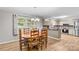 Charming dining area with an oval table, six chairs, and ample natural light next to an open kitchen at 44092 Woodhurst Rd, New London, NC 28127