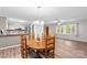 Bright dining area featuring new floors, a chandelier, and open access to the kitchen at 44092 Woodhurst Rd, New London, NC 28127