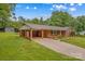 Charming brick home featuring an attached carport and large yard at 44092 Woodhurst Rd, New London, NC 28127