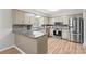 Bright kitchen with granite countertops, stainless steel appliances, and decorative tile backsplash at 44092 Woodhurst Rd, New London, NC 28127