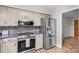 Well-equipped kitchen with stainless steel appliances, microwave, and a stylish mosaic tile backsplash at 44092 Woodhurst Rd, New London, NC 28127