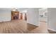 Spacious living room with a brick fireplace, modern flooring, and open access to the kitchen at 44092 Woodhurst Rd, New London, NC 28127