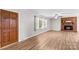 Bright living room features a brick fireplace, new floors, and a large front door at 44092 Woodhurst Rd, New London, NC 28127