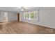 Open-concept living area with new floors, large windows, and plenty of natural light at 44092 Woodhurst Rd, New London, NC 28127