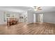 Open concept living space with dining area and a glimpse of the kitchen, featuring new floors at 44092 Woodhurst Rd, New London, NC 28127