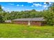 Brick house featuring a large yard with mature trees at 44092 Woodhurst Rd, New London, NC 28127