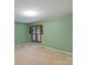 This large bedroom has a spacious closet and refreshing light green paint at 460 27Th Avenue Nw Cir, Hickory, NC 28601