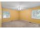 This bedroom has a ceiling fan, two windows, and natural light at 460 27Th Avenue Nw Cir, Hickory, NC 28601