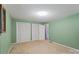 This large bedroom has a spacious closet and refreshing light green paint at 460 27Th Avenue Nw Cir, Hickory, NC 28601