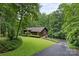 A beautiful home exterior with manicured lawn, surrounded by lush greenery and mature trees at 460 27Th Avenue Nw Cir, Hickory, NC 28601