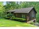 Exterior view of a single Gathering home shows the lush green landscaping and mature trees at 460 27Th Avenue Nw Cir, Hickory, NC 28601