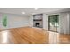 Living room with stone fireplace, wood floors and deck access at 460 27Th Avenue Nw Cir, Hickory, NC 28601