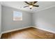 Inviting bedroom with hardwood floors, ample natural light, and a ceiling fan for added comfort at 4838 Keats Ave, Charlotte, NC 28212