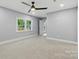 This carpeted bedroom provides a comfortable retreat, enhanced by natural light and a ceiling fan for added comfort at 4838 Keats Ave, Charlotte, NC 28212
