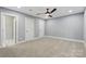 This bedroom boasts plush carpeting, a ceiling fan, and neutral paint for a comfortable and serene retreat at 4838 Keats Ave, Charlotte, NC 28212