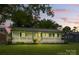 Charming single-story home with a full front porch and beautiful landscaping at 4838 Keats Ave, Charlotte, NC 28212