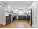 Modern kitchen featuring stainless steel appliances, granite countertops, and two-tone cabinets, blending style and functionality at 4838 Keats Ave, Charlotte, NC 28212