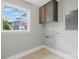 Bright laundry room area with cabinet and a sunny window at 4838 Keats Ave, Charlotte, NC 28212