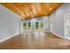 Spacious living room features stunning wooden ceilings, hardwood floors, and French doors that open to a deck, perfect for entertaining at 4838 Keats Ave, Charlotte, NC 28212