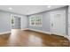 This living room features an open-concept design with hardwood floors, natural light, and freshly painted neutral colored walls at 4838 Keats Ave, Charlotte, NC 28212