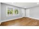 Bright living room with large windows, hardwood floors, and ample natural light, creating a warm and inviting atmosphere at 4838 Keats Ave, Charlotte, NC 28212