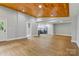 Expansive living area flows into a modern kitchen with stainless steel appliances, hardwood floors and abundant natural light at 4838 Keats Ave, Charlotte, NC 28212