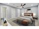 A well-lit bedroom offers a plush bed, neutral decor, and ensuite access at 4838 Keats Ave, Charlotte, NC 28212