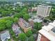 Aerial view capturing a mix of residential and commercial buildings surrounded by trees at 515 N Church St # 305, Charlotte, NC 28202