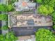 Aerial view of building rooftop, parking, and surrounding trees in a vibrant neighborhood at 515 N Church St # 305, Charlotte, NC 28202