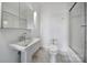 Bright bathroom featuring a pedestal sink, mirrored cabinet, and a shower-tub combination at 515 N Church St # 305, Charlotte, NC 28202