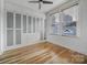 Bedroom features a fan, custom built-ins, and window with blinds at 515 N Church St # 305, Charlotte, NC 28202