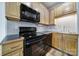 Updated kitchen features light wood cabinetry, black appliances, and modern tile backsplash at 515 N Church St # 305, Charlotte, NC 28202