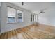 Living area featuring wood flooring, large window, and a modern ceiling fan at 515 N Church St # 305, Charlotte, NC 28202