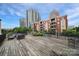 Spacious rooftop patio with outdoor seating, landscaping, and stunning city views at 515 N Church St # 305, Charlotte, NC 28202