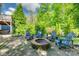 Lush backyard featuring a fire pit surrounded by chairs, creating a cozy outdoor retreat at 5518 Morris Hunt Dr, Fort Mill, SC 29708
