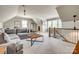 Open bonus room with large seating area, lots of natural light, and staircase at 5518 Morris Hunt Dr, Fort Mill, SC 29708