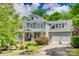 Charming two-story home featuring a covered porch, manicured landscaping, and a two-car garage at 5518 Morris Hunt Dr, Fort Mill, SC 29708